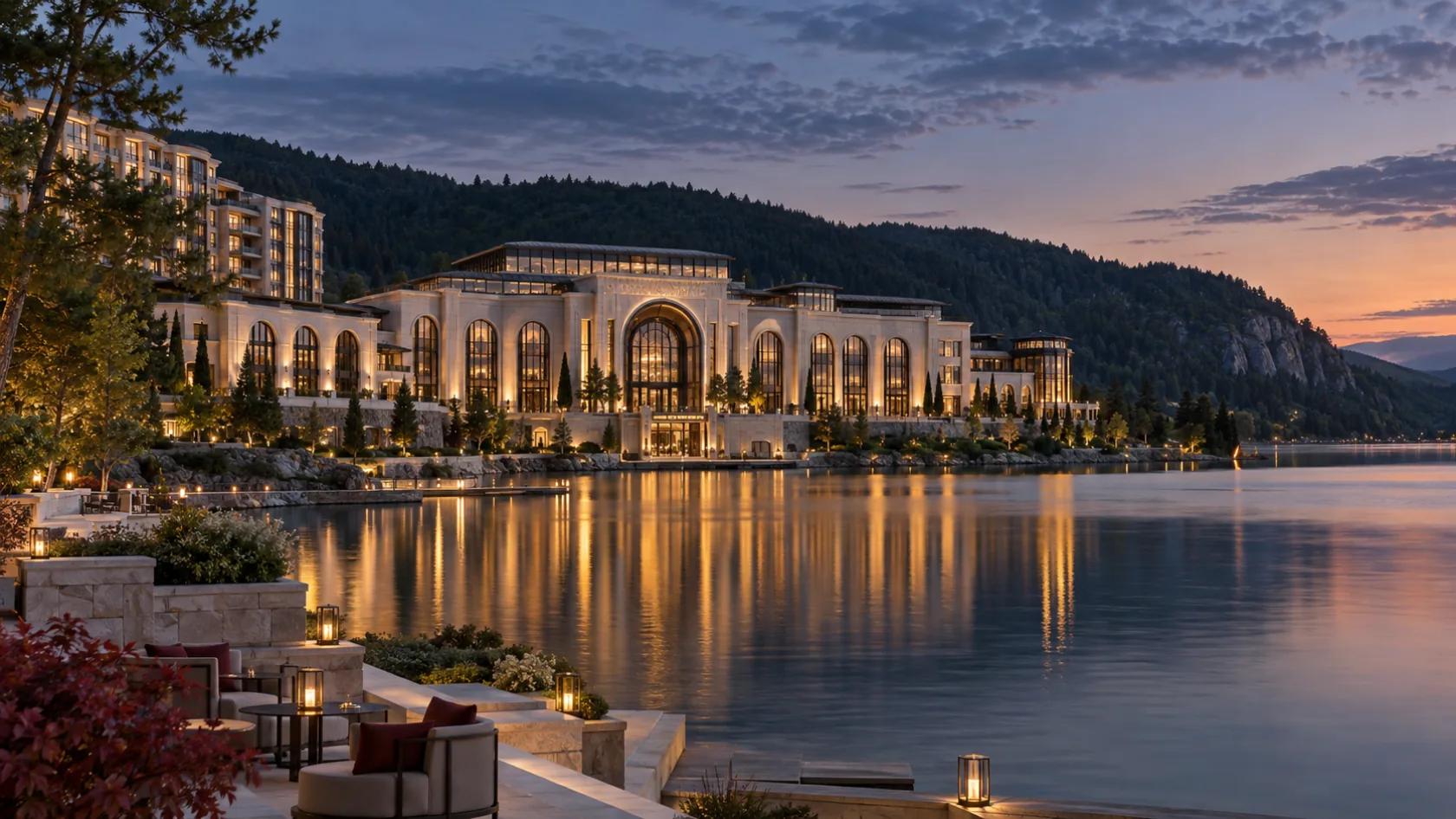 A warmly lit limestone casino resort overlooking a still Québec lake at twilight